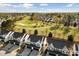 Aerial view of townhouse community near lush golf course at 5980 Osprey Cove Dr, Raleigh, NC 27604