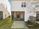 Back exterior of home featuring a screened porch and landscaped yard at 5980 Osprey Cove Dr, Raleigh, NC 27604
