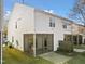 Back exterior of home featuring a screened porch and landscaped yard at 5980 Osprey Cove Dr, Raleigh, NC 27604