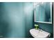 Stylish powder room features a floating sink, decorative mirror and fresh flowers at 5980 Osprey Cove Dr, Raleigh, NC 27604