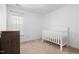 Cozy Bedroom with a crib, dresser, and a window providing natural light at 5980 Osprey Cove Dr, Raleigh, NC 27604
