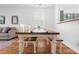 Bright dining room with modern table and wood floors at 5980 Osprey Cove Dr, Raleigh, NC 27604