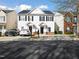 View of charming two-story townhouses with well-manicured lawns at 5980 Osprey Cove Dr, Raleigh, NC 27604