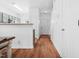 Hallway with wood floors that leads to kitchen and entry door at 5980 Osprey Cove Dr, Raleigh, NC 27604