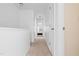 Hallway featuring white walls, neutral carpet, and white doors leading to various rooms at 5980 Osprey Cove Dr, Raleigh, NC 27604