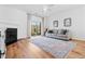 Bright living room featuring a fireplace, wood floors, area rug, and sliding glass doors at 5980 Osprey Cove Dr, Raleigh, NC 27604