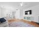 Spacious living and dining area with wood floors, fireplace, TV, sofa and lots of light at 5980 Osprey Cove Dr, Raleigh, NC 27604