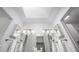 Bright bathroom featuring dual sinks, modern fixtures, skylight and a shower at 6 Preakness Dr, Durham, NC 27713