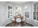 Bright breakfast nook with a round dining table and seating near large windows at 6 Preakness Dr, Durham, NC 27713