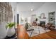Bright living room boasts a fireplace, hardwood floors, ceiling fan, and access to the outdoor deck through French doors at 6 Preakness Dr, Durham, NC 27713