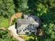 Expansive home nestled in lush greenery, featuring a spacious roof and well-manicured landscaping at 6016 Glenthorne Dr, Raleigh, NC 27613