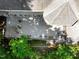Aerial shot featuring a large deck, patio, and lush greenery surrounding the property at 6016 Glenthorne Dr, Raleigh, NC 27613