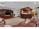 Basement featuring a classic wooden bar with barstool seating and a cozy leather sofa at 6016 Glenthorne Dr, Raleigh, NC 27613