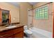 Bathroom with granite counters, and a shower-over-tub with glass block window at 6016 Glenthorne Dr, Raleigh, NC 27613