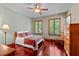 Bright bedroom with two windows, wood trim and a wooden rocking chair at 6016 Glenthorne Dr, Raleigh, NC 27613