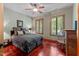 A cozy bedroom featuring wood trim, neutral paint and dual windows at 6016 Glenthorne Dr, Raleigh, NC 27613