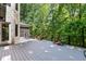 Expansive back deck surrounded by lush trees, offering a serene outdoor space perfect for relaxation at 6016 Glenthorne Dr, Raleigh, NC 27613
