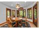 Dining room with a wooden table, four chairs, and large windows offering lots of natural light at 6016 Glenthorne Dr, Raleigh, NC 27613