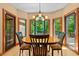 Inviting dining area with wood table and large windows offering serene outdoor views at 6016 Glenthorne Dr, Raleigh, NC 27613