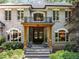 Elegant home entrance featuring a balcony, double doors, and well-maintained landscaping at 6016 Glenthorne Dr, Raleigh, NC 27613