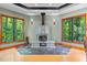 Unique stone fireplace, hardwood and tile floors and natural light from surrounding windows at 6016 Glenthorne Dr, Raleigh, NC 27613
