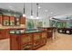 Spacious kitchen with wood cabinets, bar seating, granite countertops, and an open floor plan at 6016 Glenthorne Dr, Raleigh, NC 27613