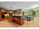 Bright kitchen with island seating, wood cabinets, and breakfast nook with natural light at 6016 Glenthorne Dr, Raleigh, NC 27613