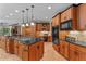 Well-equipped kitchen featuring an island gas range, wood cabinetry, and built-in appliances at 6016 Glenthorne Dr, Raleigh, NC 27613