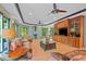Spacious living room with hardwood floors, a fireplace, and custom built-ins for storage at 6016 Glenthorne Dr, Raleigh, NC 27613