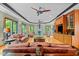 Cozy living room with a stone fireplace, hardwood floors, and large windows overlooking the greenery at 6016 Glenthorne Dr, Raleigh, NC 27613