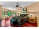 Spacious main bedroom with wood floors, ample natural light, and seating area at 6016 Glenthorne Dr, Raleigh, NC 27613