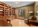 Dedicated office space with custom built-in shelving and a large window showcasing the landscape at 6016 Glenthorne Dr, Raleigh, NC 27613