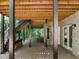 Covered patio features stone accents, wooden supports, and access to the beautifully wooded backyard at 6016 Glenthorne Dr, Raleigh, NC 27613