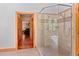 Luxurious walk-in shower with glass enclosure and tiled walls, connected to the main bedroom at 6016 Glenthorne Dr, Raleigh, NC 27613