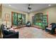 Bright sunroom with tile flooring, large windows showcasing a beautiful outdoor view and comfortable seating at 6016 Glenthorne Dr, Raleigh, NC 27613