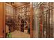 Wine cellar with custom built wooden racking and a glass encased decorative iron door at 6016 Glenthorne Dr, Raleigh, NC 27613