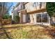 Backyard with tan siding, sliding glass doors, patio and grass at 602 Walnut Woods Dr # 62, Morrisville, NC 27560