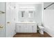 Well-lit bathroom featuring double vanities with modern fixtures, a toilet, and access to a tub-shower at 602 Walnut Woods Dr # 62, Morrisville, NC 27560