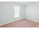 Serene bedroom with neutral walls, plush carpeting, and a window that fills the space with natural light at 602 Walnut Woods Dr # 62, Morrisville, NC 27560