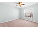 Inviting bedroom with neutral walls, plush carpeting, a ceiling fan, and large window for ample natural light at 602 Walnut Woods Dr # 62, Morrisville, NC 27560