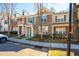 View of townhomes featuring brick, neutral siding and blue accents at 602 Walnut Woods Dr # 62, Morrisville, NC 27560