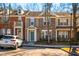Street view of townhomes featuring brick, neutral siding and blue accents at 602 Walnut Woods Dr # 62, Morrisville, NC 27560