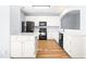 Well-lit kitchen with an island, white cabinets, stainless steel sink and modern appliances at 602 Walnut Woods Dr # 62, Morrisville, NC 27560