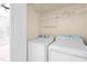 Practical laundry room with a washer, dryer, and shelving for organized storage at 602 Walnut Woods Dr # 62, Morrisville, NC 27560