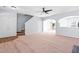 Spacious living room with staircase, modern ceiling fan, and views to other living spaces at 602 Walnut Woods Dr # 62, Morrisville, NC 27560