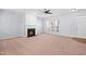 Comfortable living room with cozy fireplace, modern ceiling fan and lots of natural light at 602 Walnut Woods Dr # 62, Morrisville, NC 27560