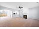 Bright living room featuring kitchen view, fireplace, and sliding glass doors to outdoor fenced area at 602 Walnut Woods Dr # 62, Morrisville, NC 27560