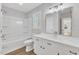 Bright bathroom features a shower over tub and a vanity with a window at 612 Miller Rd, Hillsborough, NC 27278