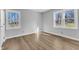 Bedroom featuring wood flooring and natural light from two windows at 612 Miller Rd, Hillsborough, NC 27278