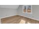 Bedroom with wood flooring and large window offering natural light at 612 Miller Rd, Hillsborough, NC 27278